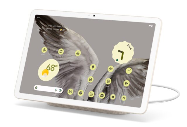 A Pixel Tablet, showing a bunch of yellow app icons and widgets, with bird wings as a background.