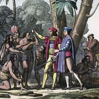 Christopher Columbus arriving in the New World, 1492. Columbus presents gifts to the first natives to greet him on his landing in America. Columbus set out to discover a westward route to Asia. (Native Americans, colonization of the Americas)