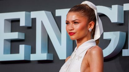 A close up of Zendaya wearing a white halter gown covered in sequin tennis racquets at the Challengers London premiere