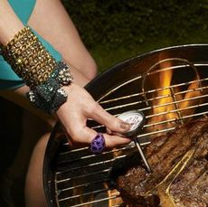 Woman testing temperature of steak