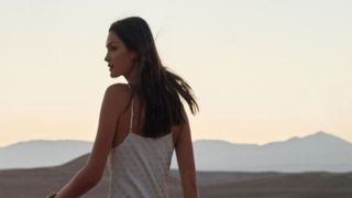 A woman looking out at a desert horizon