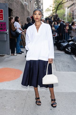 A photo of Gabrielle Union carrying the Caroline Bag in Oat at 92Y on April 28 in New York City.