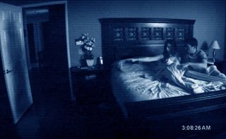 a found footage shot of a couple in bed in Paranormal Activity