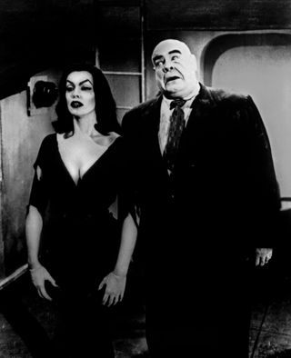 a spooky looking woman and a man in a suit looks surprised in the movie Plan 9 from outer space