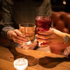 Young female friends toasting glass after work