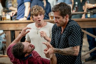 Jake Gyllenhaal (right) subdues an attacker while Lukas Gage looks on in shocked, in the 2024 movie 'Road House'