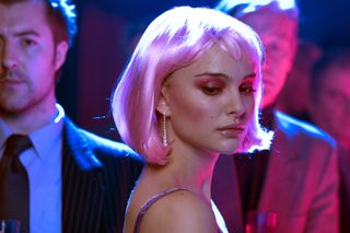 natalie portman wears a pink wig and pink makeup in the club scene of closer while men surround her