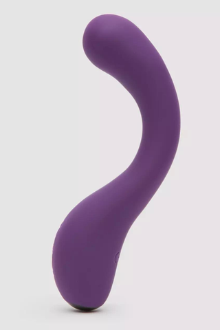 purple curved g spot vibrator on a gray background