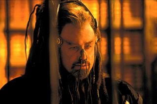 john travolta with an elaborate wig and thing covering his nose in the movie Battlefield earth