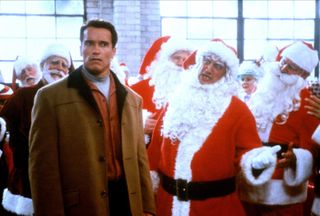 arnold schwarzenegger stands by a group of santa clauses in the movie Jingle all the way