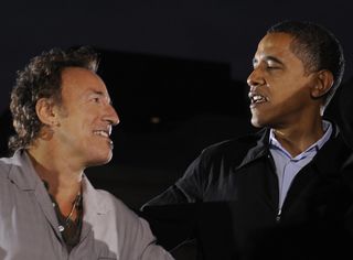 bruce springsteen and barack obama looking together and smiling at an event for their podcast Renegades: Born in the USA