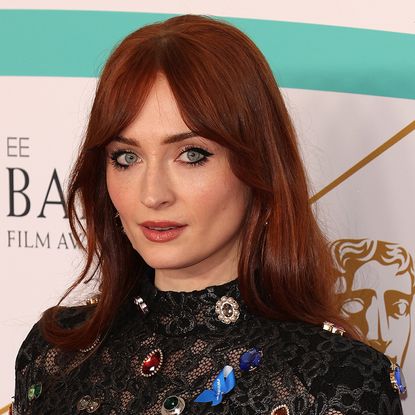 Sophie Turner with red hair and bangs at the EE BAFTA Film Awards in London on February 19, 2023