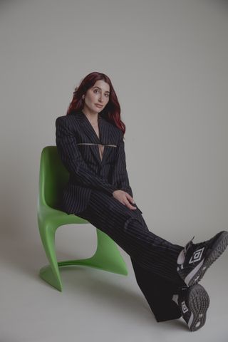 starface founder and ceo julie schott posing in a suit and sneakers