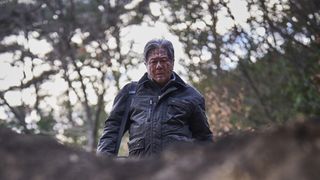 a man (choi min-sik) splattered with blood looks down into a hole