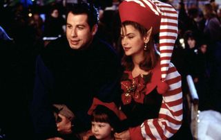 john travolta and christy alley wearing a christmas elf costume in the movie Look who’s talking now