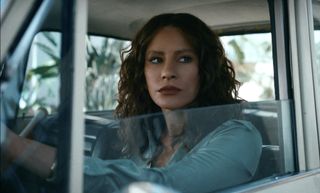 a woman (Sofia Vergara as Griselda) sits in a car and looks out of the lowered window