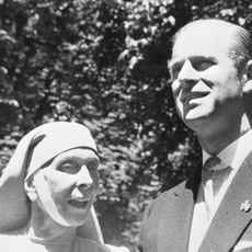 Princess Alice wears a nun's habit as she poses with her son Prince Philip, who wears a suit