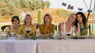 Sarah Greene, Eva Birthistle, Sharon Horgan, Anne-Marie Duff and Eve Hewson as the garvey sisters sitting at a table at a wedding in "Bad Sisters."