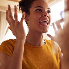 Facial expression, Yellow, Smile, Chin, Gesture, Fun, Hand, Shoulder, Happy, Finger, 