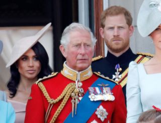 Meghan, then-Prince Charles, and Prince Harry stand on the balcony of Buckingham Palace during Trooping The Colour 2018 on June 9, 2018 in London, England.