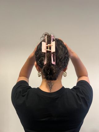 A photo of Gabrielle Ulubay from the back with her hair up in a bun with a claw clip