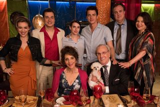 the cast of the rom-com of Little Italy including hayden christiansen and emma roberts pose around a table