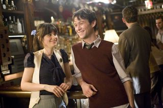 zooey deschanel and joseph gordon levitt as summer and tom standing in a bar in 500 days of summer