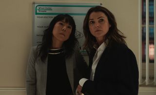 Ali Ahn as Eidra Park and Keri Russell as Kate Wyler standing in front of a white board of their conspiracy theory in the diplomat season 2