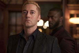 Ryan Eggold as Ed Ramsey, with Aldis Hodge as Alex Cross blurry in the background, in 'Cross.'