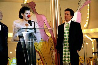 sandra bullock wears a red clown nose and hugh grant wears a massive tie on stage in two weeks notice