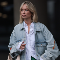 Nadine Berneis seen wearing Balenciaga light blue oversized logo denim / jeans jacket, Black Palms The Label white cotton oversized buttoned shirt, Karo Kaur Label green / white wide leg pants, Gucci beige / creamy white leather bag, on March 06, 2024 in Munich, Germany. (Photo by Jeremy Moeller/Getty Images)