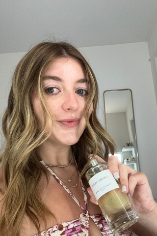 Samantha holding a bottle of Dior Dioriviera Eau de Parfum