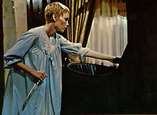 mia farrow holds a knife over a baby carriage in Rosemary's Baby