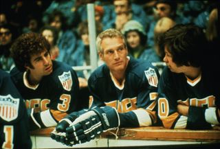 paul newman and hockey players at the ice rink in the movie slap shot