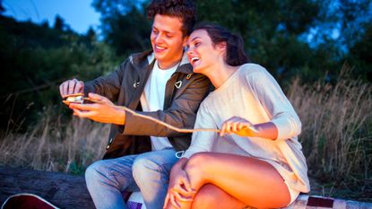 couple making smores at bonfire, a cheap date idea