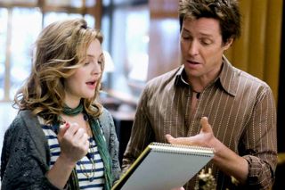 drew barrymore and hugh grant singing and holding a book of lyrics in the movie music and lyrics