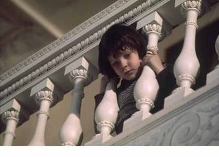 little boy looks over a staircase in The Omen