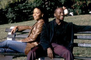 sanaa lathan and taye diggs sit on a bench next to each other in brown sugar