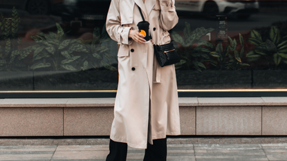 Woman walking around the city with a cup of coffee with crossbody bag 