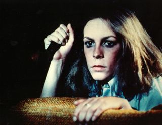 jamie lee curtis holds a knife as laurie strode in Halloween