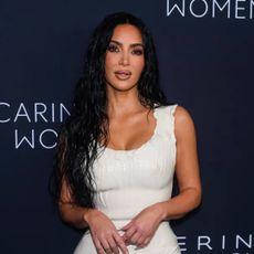 kim kardashian wearing a white balenciaga dress on the red carpet