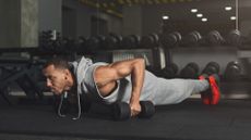 A man performing dumbbell push ups during fullbody workout