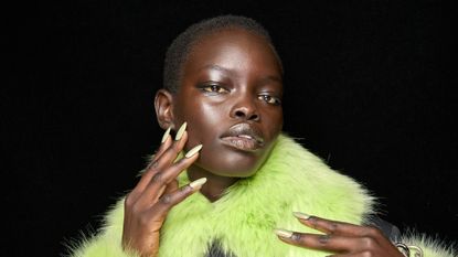 woman with green collar and nails showcasing minimized pores