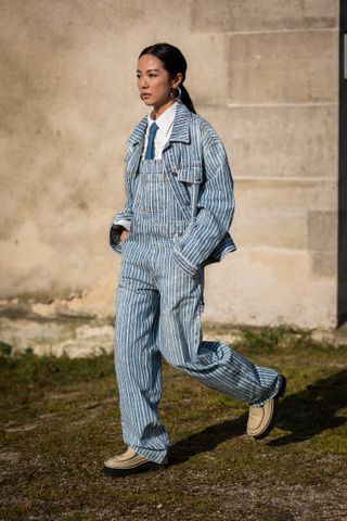 woman wearing striped overalls and matching jacket