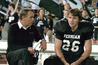 billy bob thornton and a football player sitting on a bench on the field in the movie friday night lights