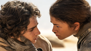 timothee chalamet and zendaya look into each others' eyes in the desert in dune part two