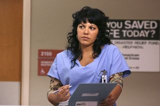 Dr. Callie Torres holds a clipboard and wears scrubs on grey's anatomy