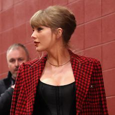 Taylor Swift enters Arrowhead Stadium for the Chiefs Game wearing a Versace blazer and a French twist