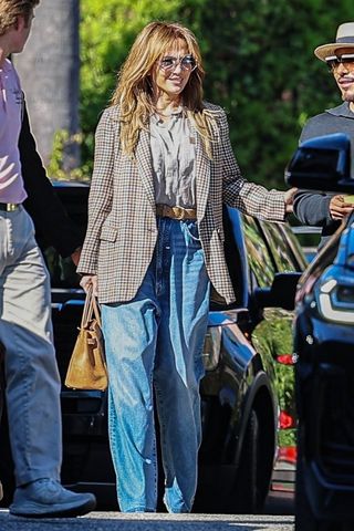 Jennifer Lopez wears a plaid blazer with baggy jeans and a brown birkin bag in Los Angeles