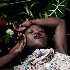 woman laying down among flowers